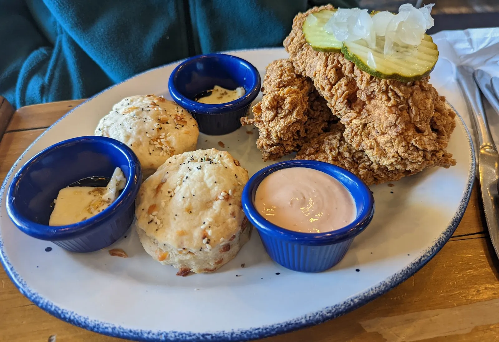 Fried chicken tenders with pickles, two biscuits and dipping sauces at Mama Bird Southern Kitchen